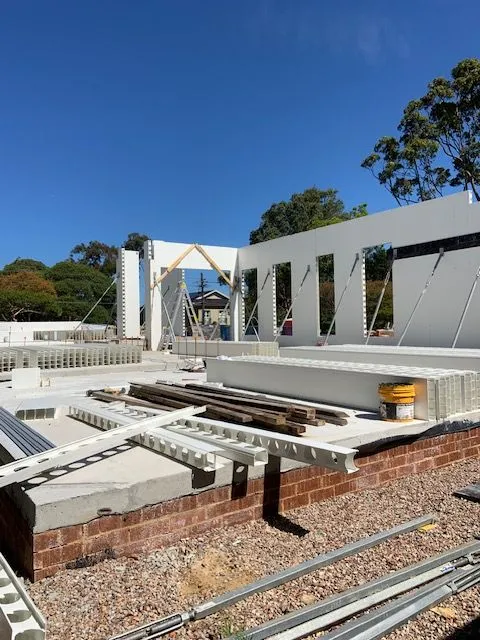 Dincel wall panels set out on a residential construction site under blue sky